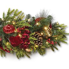 a christmas garland with pine cones, red and green ornaments and lights on it's sides