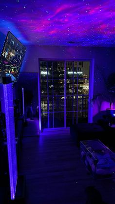 a living room with purple and blue lighting