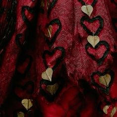 a red dress with black and gold hearts on it