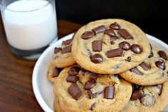 chocolate chip cookies on a plate next to a glass of milk