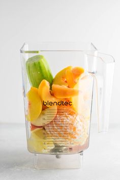 a blender filled with lots of different types of fruit in it's glass container