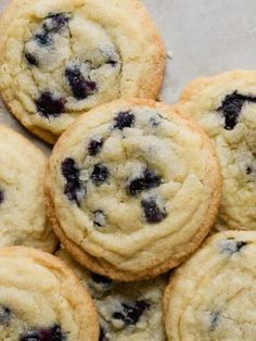 a pile of blueberry cookies sitting on top of a table