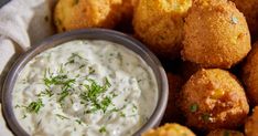 a basket filled with tater tots and dip