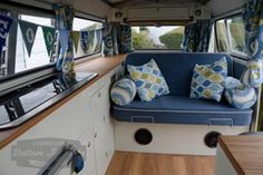 the interior of a camper with blue and green decor