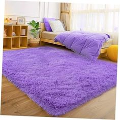 a bright purple rug is in the middle of a room with a bed and window