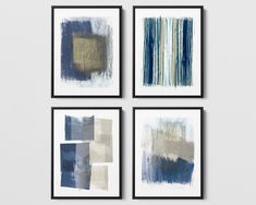 four abstract paintings hanging on the wall in three different frames, each with blue and white paint