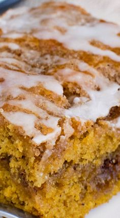 a close up of a piece of cake on a plate with icing drizzled