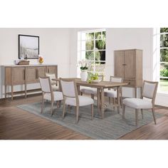 a dining room table with white chairs and an armoire in front of a window