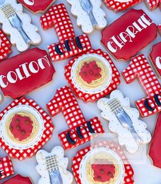 red and white decorated cookies with the word colot on them are arranged in rows