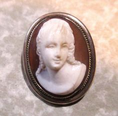 Antique 1890-1900 Victorian high relief pressed glass oval cameo portrait brooch pin/pendant combination. 925 silver frame, marked "Camexco & Co., .925", 28mm by 22mm, 1 brooch.  Clearly marked on the back side.  This brooch is in wonderful as found  antique/vintage condition with no issues, no cracks and nicks. It has not been cleaned or polished. You'll receive the antique 1890-1900 Victorian high relief pressed glass oval cameo portrait brooch pin/pendant combination as seen in the photos wit White Oval Cameo Brooches, Oval Silver Cameo Brooch, High Relief, Pin Pendant, Pressed Glass, Silver Frame, Brooch Pin, 925 Silver, Favorite Jewelry