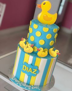 a birthday cake with rubber ducks on top