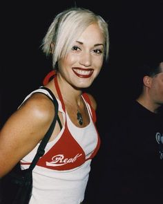 a woman with white hair smiling at the camera