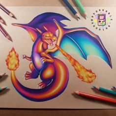 a drawing of a dragon on paper with colored pencils