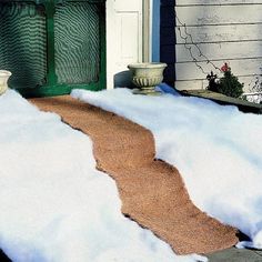 snow is piled on the ground next to a fire hydrant in front of a house