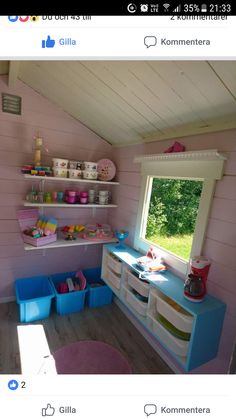 a pink and blue room with shelves filled with dishes on top of each shelf in front of a window