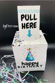 a white box with a sign that says pull here happy birthday