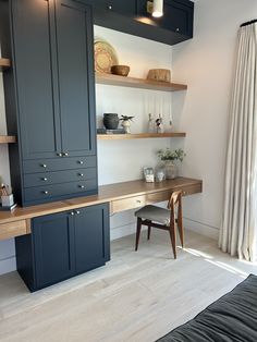 a room with shelves, desk and chair in it's center area is shown