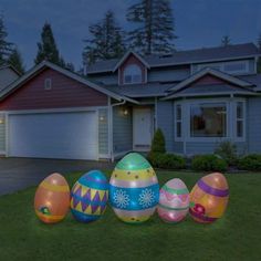 lighted easter eggs in front of a house at night