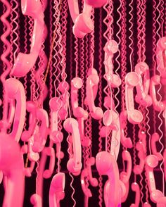 pink telephones are hanging from the ceiling