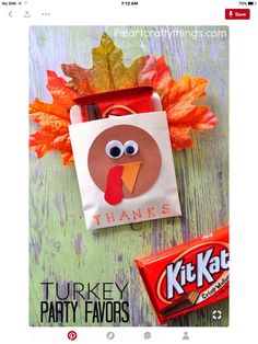 an image of a turkey party favors on a wooden table with candy bars and leaves