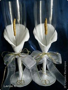 two wine glasses with gold rims and ribbons