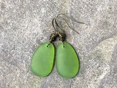 These olive green sea glass earrings (cultured) are perfect for summer! I just adore this color, and how can you go wrong with beach glass jewelry? The frosted glass drops are 36mm x 20mm & I used antique brass plated wire & ear hooks (lead & nickel-safe) to create these dangles. I love these earrings for a summer birthday gift. Please ask if you have any questions. Approx. total earring length: 2 1/2" Thanks for supporting small businesses! Green Recycled Glass Earrings For Beach, Handmade Sea Glass Green Earrings, Green Sea Glass Earrings For Gift, Green Sea Glass Earrings With Ear Wire, Nickel-free Green Earrings For Beach, Surfer Girl Gifts, Beach Glass Jewelry, Beachglass Jewelry, Sea Glass Earrings