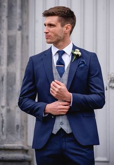 a man in a blue suit and tie