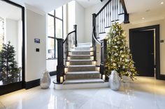 the stairs are decorated with christmas trees and lights, along with other decorations on either side