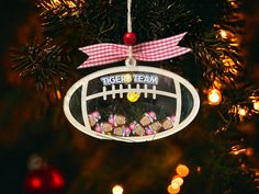 a football ornament hanging from a christmas tree