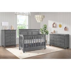 a baby crib and dresser in a room