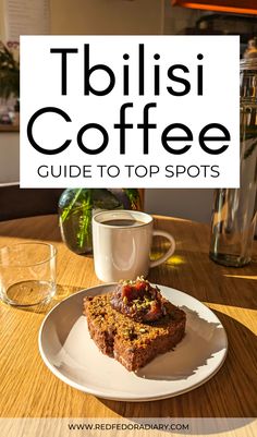 a white plate topped with food on top of a wooden table next to a cup of coffee