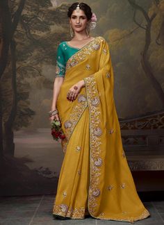 This premium saree features a luxurious mustard tissue organza silk material with intricate embroidery, perfect for bridal wedding wear. The embroidered fancy designer blouse adds a stylish touch to this elegant piece. Elevate your special occasion wardrobe with this must-have saree. The unstitched blouse can be customized upto 44 inches. Do Note: All the accessories shown are for styling purpose only. Slight color variation may occur due to photographic reasons. Fall and Pico : Done Draping Sar Mustard Yellow Saree, Designer Silk Sarees, Yellow Saree, Ghagra Choli, Art Silk Sarees, Trendy Sarees, Embroidery Saree, Top Models, Organza Saree