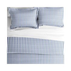 the blue and white striped bedding is made with two pillows, one on top of the