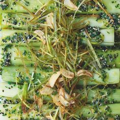 celery and herbs are mixed together on a cutting board for garnish