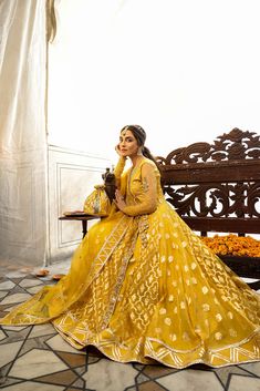 Yellow Mehndi Dress in Bridal Angrakha Frock Style is an epitome of tradition and royalty that wins everyone's hearts at the very first glance. The lavish dabka and mirror work details make this stunning Pakistani Bridal Dress your foremost priority to have a royal look on Mehndi. Angrakha: The beautiful Angrakha Frock in the yellow shade is a breathtaking attire to have a traditional look on the Mehndi. The hand-crafted embellishments of Kundan zari and dabka make this stunning Angrakha Dress a Yellow Mehndi Dress, Angrakha Frock, Turkish Wedding Dress, Angrakha Dress, Pakistani Bridal Dress, Mehndi Dress, Angrakha Style, Maya Ali, Frock Style