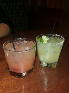 two drinks sitting on top of a wooden table