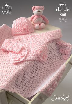 a crocheted baby blanket with a teddy bear on top and the words, king cole