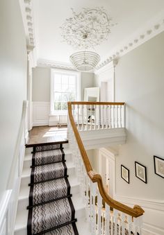 the stairs in this house are lined with pictures