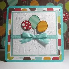 a close up of a card on a table with balloons and polka dotes in the background