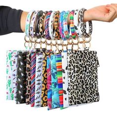 a person holding up a bunch of bracelets