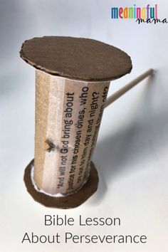 a roll of toilet paper sitting on top of a wooden stand with the words bible lesson about perseverance