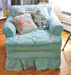 a blue chair with some pillows on it