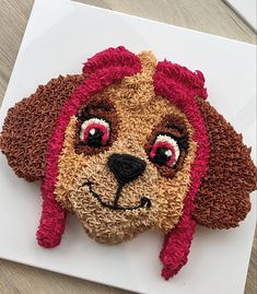 there is a stuffed animal that looks like a dog's head on the table