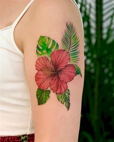 a woman with a flower tattoo on her arm