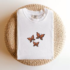 Comfort Colors Butterflies T-Shirt, Embroidered Butterflies Shirt, Cute Butterfly Shirt, Embroidered Insect T-shirt, Custom Butterfly Shirt This embroidered butterflies shirt is everything. Perfect to wear to show your love for butterflies! ✨ 100% Cotton ✨ Pre-shrunk ✨ Relaxed fit Care: Machine wash: warm (max 40C or 105F) Tumble dry: low Do not iron directly on the design REFUNDS AND EXCHANGES All items are made to order using multiple suppliers to ensure quick worldwide shipping. For this reason we are unable to accept returns/exchanges unless there's a defect in the item you've received. Thank you so much for shopping! Please send me a message if you have any questions, concerns or custom requests. White Butterfly T-shirt For Spring, White Cotton T-shirt With Butterfly Print, Casual White Top With Butterfly Embroidery, White Cotton Top With Butterfly Print, Short Sleeve Cotton Tops With Butterfly Embroidery, White Cotton Tops With Butterfly Embroidery, Cotton Butterfly Print Crew Neck Top, Cotton Crew Neck Top With Butterfly Print, Spring Crew Neck T-shirt With Butterfly Embroidery