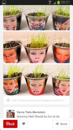 there are many small pots with grass growing out of the top, and one has a child's face on it