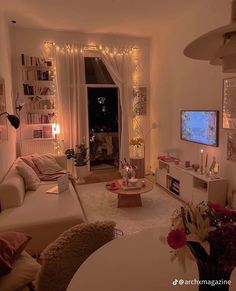 a living room filled with furniture and a flat screen tv sitting on top of a wall