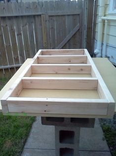 a wooden table sitting on top of a cement block