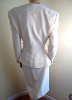 "Perfect condition Lillie Ruben suit with lots of beading and Rhinestone Button and cuffs totally lined in white acetate suit is wool with off white bugle beads made in Hong kong skirt measures 34\" waist 28 length Jacket waist 34, bust 40\" slight peplum super glam" Elegant Fitted Sets With Pearl Embroidery, Formal Cream Sets With Pearl Embroidery, Double-breasted Wedding Blazer With Double Button Closure, Tailored Cream Set For Wedding, Fitted White Sets With Pearl Embroidery, Fitted Vintage White Sets, Elegant Embellished White Set, Elegant White Embellished Set, Vintage Long Sleeve Wedding Suits