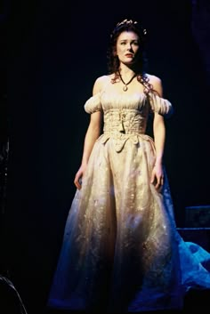 a woman in a dress standing on stage